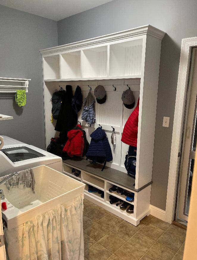 Elegant mudroom coat rack providing stylish organization for coats and accessories in an entryway.